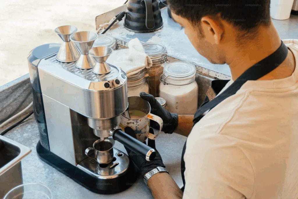 A barista preparing espresso using a semi-automatic machine