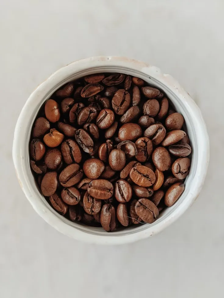 Perfectly roasted espresso beans in a round jar