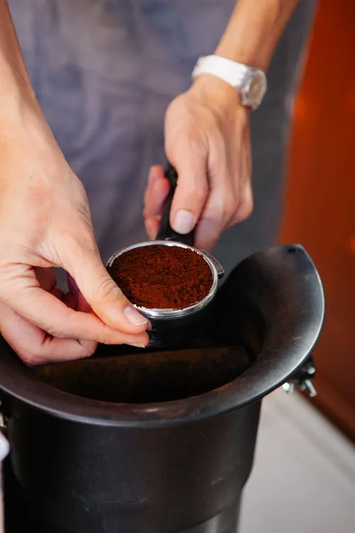 Burr grinder dispensing fresh espresso grounds