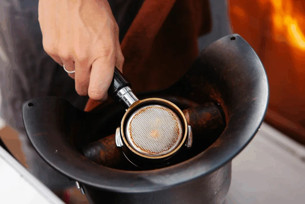 Used espresso pucks in a stainless steel knock box.