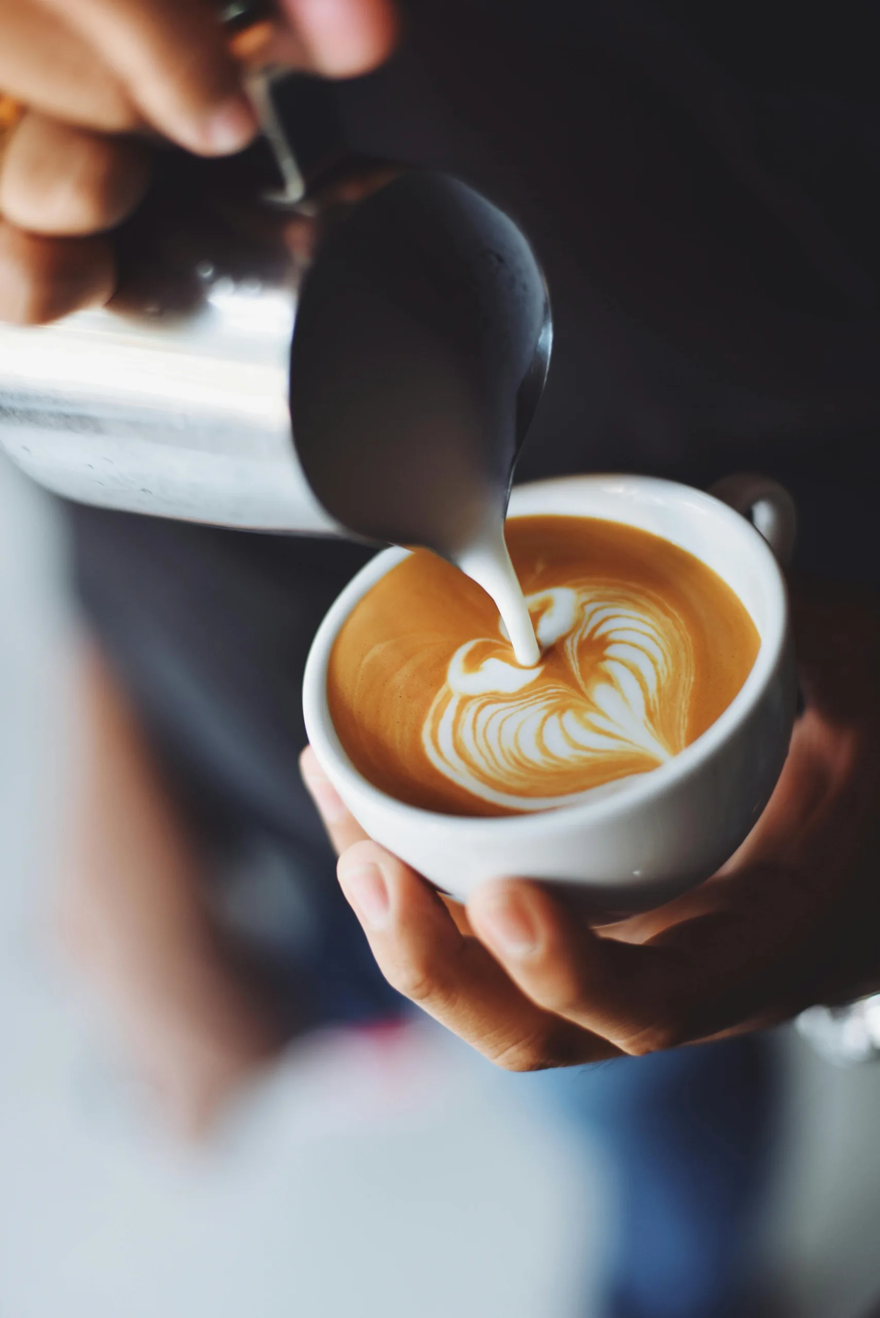 Selection of espresso drinks including latte, cappuccino, and macchiato on a wooden tray
